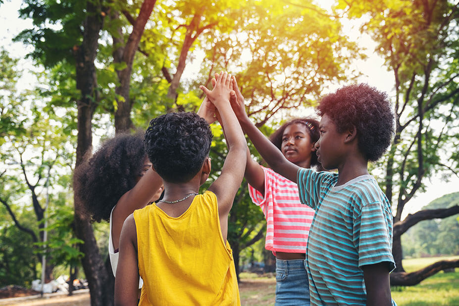 community-Group-of-children-joining-hands-together-standing-in-the-park,-Kids-playing-teamwork-outdoor