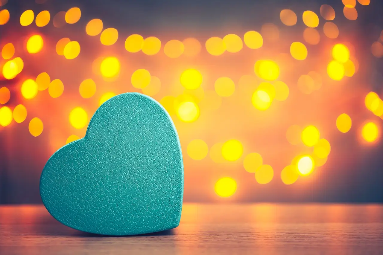 teal-heart-in-front-of-lights